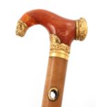 An 18th century gold-mounted amber walking cane handle, later converted to a parasol, the gold