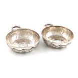 A pair of silver wine tasters, by D and J Wellby, London 1928, circular form, embossed trailing