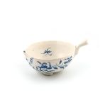 An English porcelain blue and white cup or wine taster, c.1755 or later, of peach shape, painted