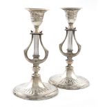 A pair of late-Victorian silver lyre candlesticks, by Hawksworth, Eyre & Co, Sheffield 1889 and