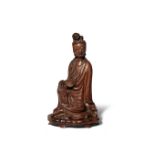 A CHINESE WOOD FIGURE OF GUANYIN 17TH/18TH CENTURY She sits in a relaxed pose with her right hand