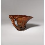 λ A CHINESE RHINOCEROS HORN 'LOTUS' LIBATION CUP 17TH/EARLY 18TH CENTURY Formed as a trumpet-shaped