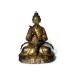 A CHINESE GILT-BRONZE FIGURE OF SHANGQING QING DYNASTY Depicted seated with crossed legs wearing