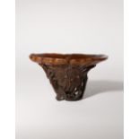 λ A LARGE CHINESE RHINOCEROS HORN 'LOTUS' LIBATION CUP 17TH/EARLY 18TH CENTURY Formed as a single