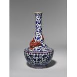 A CHINESE BLUE AND RED-ENAMELLED 'CHILONG' BOTTLE VASE LATE QING DYNASTY Decorated in relief with