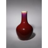 A CHINESE FLAMBE GLAZED BOTTLE VASE 18TH CENTURY With an ovoid body and tall cylindrical neck, the