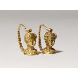 A PAIR OF CENTRAL ASIAN GOLD EARRINGS PROBABLY 3RD/4TH CENTURY AD Each depicting a female head