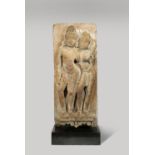 AN INDIAN SANDSTONE STELE OF A COUPLE PROBABLY 11TH/12TH CENTURY Carved in high relief with the