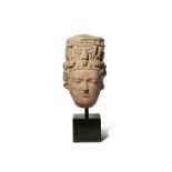 A GANDHARAN TERRACOTTA HEAD OF BUDDHA 3RD-5TH CENTURY AD The face finely rendered with well-