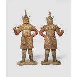 A PAIR OF CHINESE PAINTED POTTERY FIGURES OF GUARDIANS TANG DYNASTY Each depicted standing with