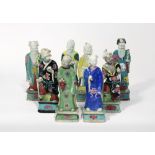 EIGHT CHINESE FAMILLE ROSE FIGURES OF DAOIST IMMORTALS LATE 18TH CENTURY Standing on rectangular