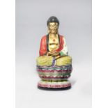 A CHINESE FAMILLE ROSE AND GILT-DECORATED FIGURE OF BUDDHA SHAKYAMUNI 20TH CENTURY Seated in