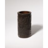 A CHINESE BAMBOO 'LANDSCAPE' BITONG 19TH CENTURY The cylindrical brushpot carved in relief with a