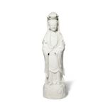 A CHINESE BLANC DE CHINE FIGURE OF GUANYIN 18TH CENTURY She stands upon a domed base of swirling