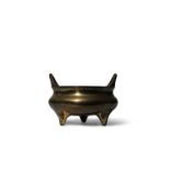 A CHINESE BRONZE TRIPOD INCENSE BURNER QING DYNASTY The compressed circular body raised on three