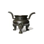 A CHINESE BRONZE TRIPOD INCENSE BURNER, DING MING DYNASTY The compressed circular body supported