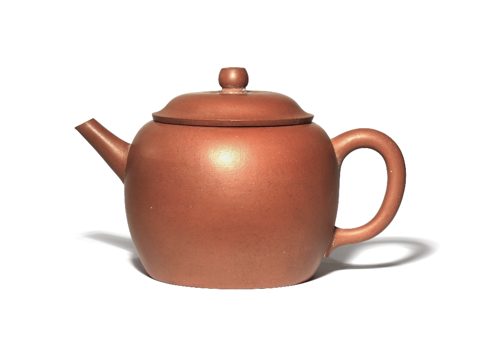 A CHINESE YIXING TEAPOT AND COVER QING DYNASTY The plain ovoid body with a loop handle and