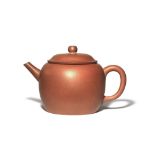 A CHINESE YIXING TEAPOT AND COVER QING DYNASTY The plain ovoid body with a loop handle and