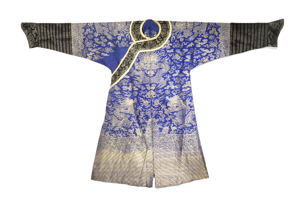 A CHINESE BLUE-GROUND EMBROIDERED SILK 'DRAGON' ROBE LATE QING DYNASTY Decorated in gold with