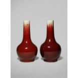 TWO CHINESE FLAMBE GLAZED BOTTLE VASES QING DYNASTY The flecked red glazed draining from the rims,