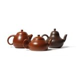 THREE CHINESE YIXING TEAPOTS AND COVERS QING DYNASTY Each with an upright spout and a loop handle to