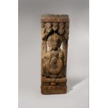 A NEPALESE CARVED WOOD ARCHITECTURAL FRAGMENT C.12TH CENTURY Worked in relief with a deity
