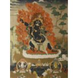 A TIBETAN THANGKA 19TH CENTURY Painted with a crowned wrathful deity standing before flames in a
