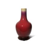A CHINESE FLAMBE GLAZED BOTTLE VASE 18TH/19TH CENTURY The ovoid body rising to a tall cylindrical