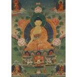 A TIBETAN THANGKA 19TH CENTURY Depicting a seated figure of Ratnasambhava raised on a lotus