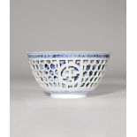 A CHINESE BLUE AND WHITE DOUBLE-WALLED BOWL KANGXI 1662-1722 The U-shaped body rising from a short