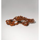 A CHINESE CARVED BOXWOOD BRUSH REST 20TH CENTURY Delicately carved as flowering prunus branches,