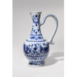 A CHINESE BLUE AND WHITE EWER TRANSITIONAL C.1640 The ovoid body rising from a short spread foot