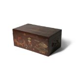 A BROWN LACQUER RECTANGULAR BOX 19TH CENTURY With a hinged lid, decorated in red and gold with a