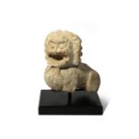 A CHINESE CARVED STONE LION FRAGMENT TANG DYNASTY The lion depicted with bulging eyes beneath a