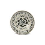 A LARGE VIETNAMESE BLUE AND WHITE DISH 15TH/16TH CENTURY Rising from a short straight foot to an