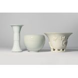 THREE CHINESE WHITE GLAZED ITEMS QING DYNASTY Comprising: a blanc de Chine libation cup moulded with