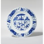 A CHINESE BLUE AND WHITE 'EIGHT HORSES' PLATE KANGXI 1662-1722 Painted with a central scene of the