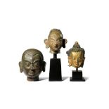 AN INDIAN BRONZE HEAD AND TWO TIBETAN HEADS 18TH/19TH CENTURY The Indian head depicting the