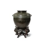 A CHINESE BRONZE OVOID VASE 17TH/18TH CENTURY Cast with taotie masks against a broad leiwen band