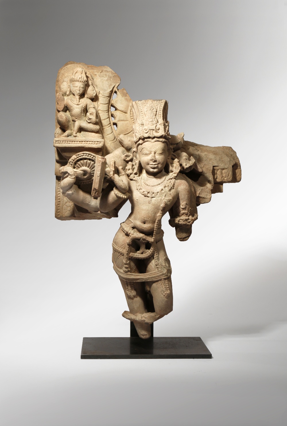 AN INDIAN PINK SANDSTONE CARVING OF VISHNU VAIKUNTHA C.10TH CENTURY The four-armed deity stands in