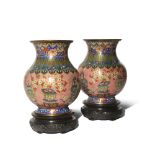 A PAIR OF CHINESE CLOISONNE VASES EARLY 19TH CENTURY Brightly decorated with vessels containing