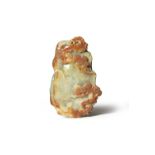 A CHINESE CELADON AND RUSSET JADE DESK WEIGHT QING DYNASTY Formed as a rocky boulder, one side