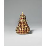 AN INDIAN GOLD GEM-SET KOHL BOTTLE AND COVER C.1900 The gold pear-shaped body richly adorned with