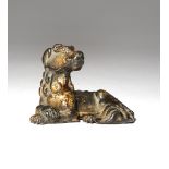A CHINESE GILT-LACQUERED BRONZE MODEL OF A RECUMBENT CANID MING/QING DYNASTY Sitting with its head