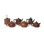 SIX CHINESE YIXING TEAPOTS AND COVERS QING DYNASTY/REPUBLIC PERIOD One decorated in relief with