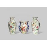 THREE CHINESE FAMILLE ROSE WALL VASES 19TH CENTURY Comprising: a pair decorated with butterflies