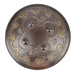 An Indian shield (dhal), 19th century, iron, 12 in., four bosses enclosed by a looping and knotted