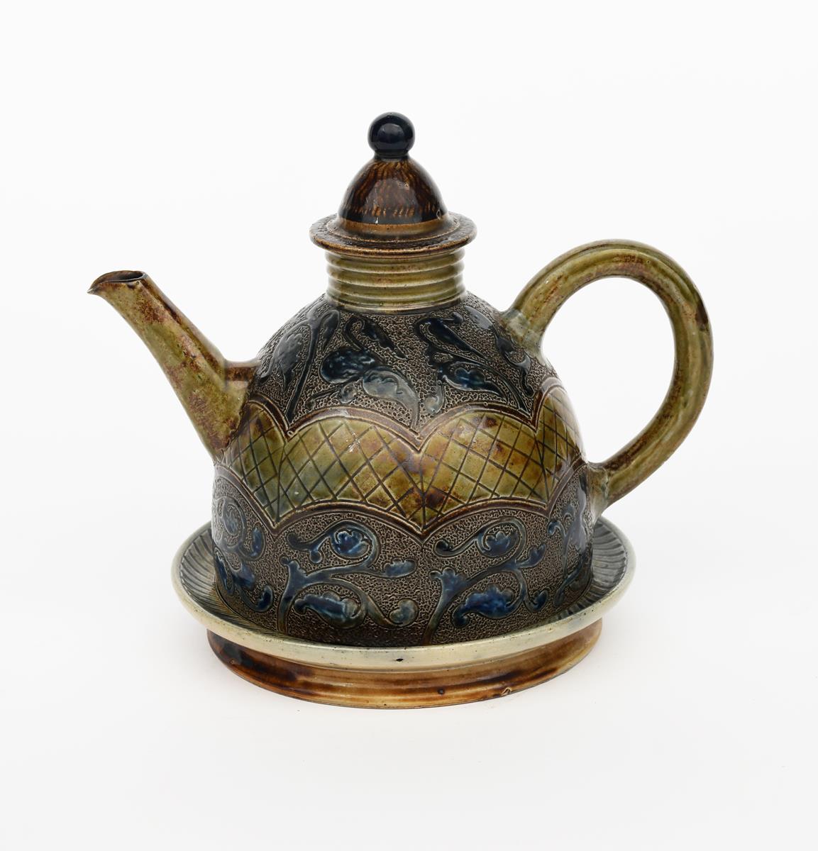 A rare Martin Brothers stoneware teapot, cover and stand by Robert Wallace Martin, dated 1879,