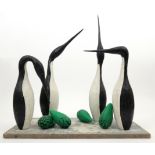 ‡ Guy Taplin (b. 1939) Four guillemots and four eggs Signed and titled Painted wood with glass