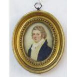 Early 19th century miniature bust length portrait of oval form showing a gentleman in blue coat